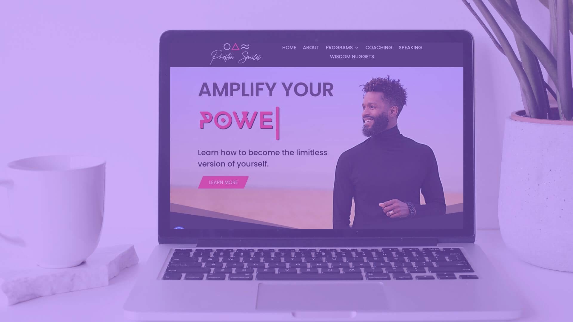 Computer displaying a form on a life coaching website, with notepad and indoor plant on the desk, symbolizing a blend of technology and personal touch in coaching