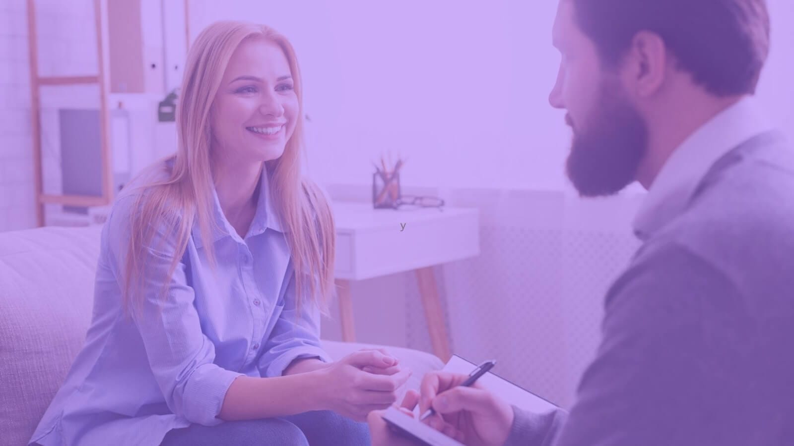 Group of individuals engaged in a workshop with a life coach, discussing strategies and growth
